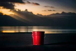 a red bucket sits on the beach at sunset. AI-Generated photo