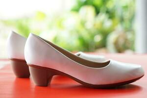 White shoes for woman. Concept, fashion, formal and polite footwears for office workers or nurses to wear shoes in office or hospital to match with white uniform or other dress. Footwears. photo