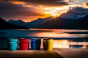 four colorful buckets sit on a dock at sunset. AI-Generated photo