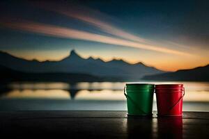 two red and green buckets sitting on a table in front of a lake. AI-Generated photo