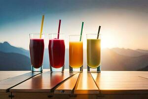 four glasses of juice on a table with mountains in the background. AI-Generated photo