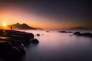 a man stands on rocks at the shore of a body of water. AI-Generated photo