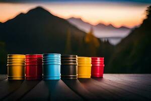 colorful barrels on a wooden table with mountains in the background. AI-Generated photo