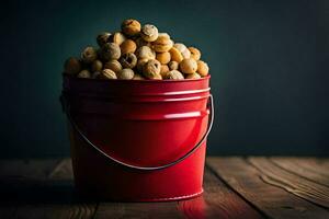 un rojo Cubeta lleno con nueces en un de madera mesa. generado por ai foto