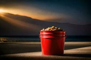 a red bucket filled with nuts on the beach at night. AI-Generated photo