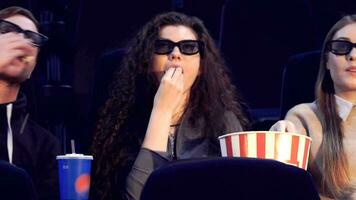 Man takes popcorn from the bucket at the movie theater video