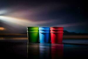 three colorful plastic cups sit on the ground at night. AI-Generated photo