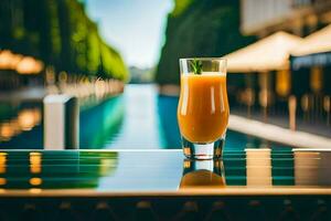 a glass of orange juice sitting on a table near a pool. AI-Generated photo