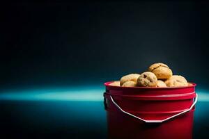 a red bucket filled with doughnuts sitting on a table. AI-Generated photo