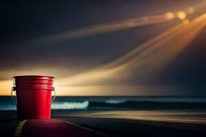 a red bucket sitting on the road near the ocean. AI-Generated photo