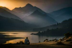 a man sitting on the edge of a lake with a mountain in the background. AI-Generated photo