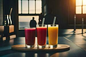 Tres diferente jugos sentar en un bandeja en frente de un ventana. generado por ai foto