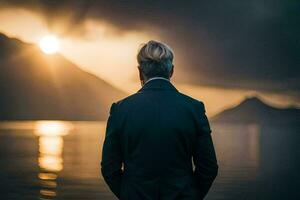 a man in a suit stands in front of a lake at sunset. AI-Generated photo