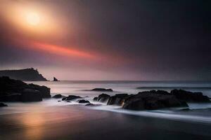 un hermosa puesta de sol terminado el Oceano con rocas y agua. generado por ai foto