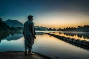 a man in a robe stands on the edge of a lake at sunrise. AI-Generated photo