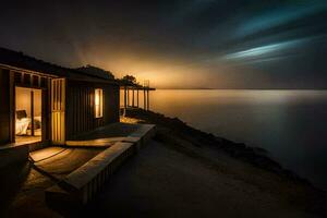 a cabin on the beach at night with a light shining on it. AI-Generated photo