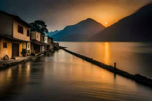 un lago y casas en el antecedentes a puesta de sol. generado por ai foto