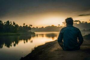 un hombre sentado en el lado de un río a puesta de sol. generado por ai foto