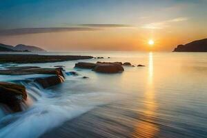 puesta de sol terminado el mar, rocas, agua, montañas, hd fondo de pantalla. generado por ai foto