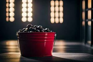 a red bucket filled with black olives sitting on a wooden floor. AI-Generated photo
