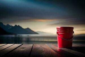 a red bucket sitting on a wooden deck overlooking a lake. AI-Generated photo