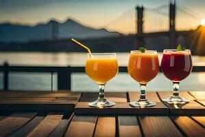 three glasses of juice with a bridge in the background. AI-Generated photo