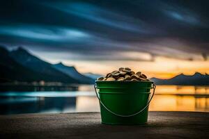 a bucket of coins sitting on the ground near a lake. AI-Generated photo