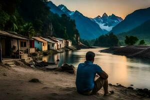 a man sitting on the shore of a river with houses in the background. AI-Generated photo