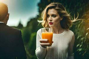 a woman holding a glass of orange juice photo