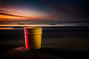 un amarillo Cubeta se sienta en el playa a puesta de sol. generado por ai foto