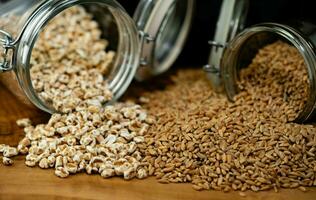 a pile of spelt Triticum aestivum spelta on olive wood photo