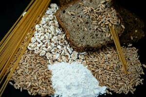 a pile of spelt Triticum aestivum spelta on olive wood photo