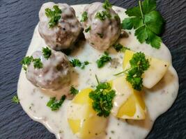 Koenigsberger Klopse meatballs and Potatoes with caperberries Sauce traditional german cuisine photo