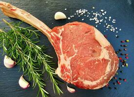 Tomahawk steak with herbs and spices photo