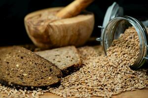 a pile of spelt Triticum aestivum spelta on olive wood photo