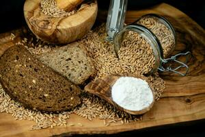 a pile of spelt Triticum aestivum spelta on olive wood photo