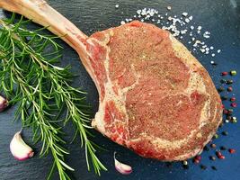 Tomahawk steak with herbs and spices photo