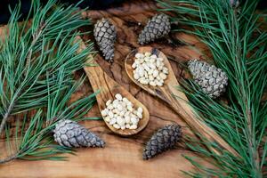 Cedar cones and nuts on olive wood photo