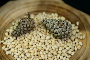 Cedar cones and nuts on olive wood photo