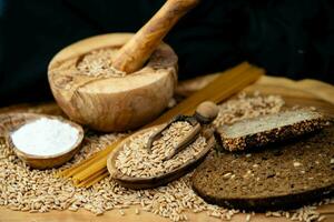 a pile of spelt Triticum aestivum spelta on olive wood photo