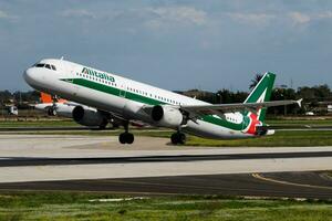 Alitalia passenger plane at airport. Schedule flight travel. Aviation and aircraft. Air transport. Global international transportation. Fly and flying. photo