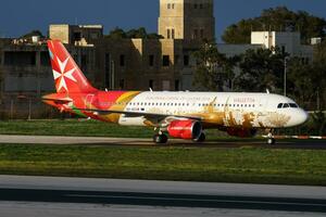 Air Malta passenger plane at airport. Schedule flight travel. Aviation and aircraft. Air transport. Global international transportation. Fly and flying. Arrival and landing. photo