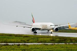 Emirates passenger plane at airport. Schedule flight travel. Aviation and aircraft. Air transport. Global international transportation. Fly and flying. Departure and take off. photo