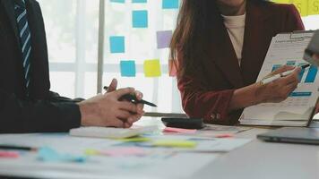 Business team collaboration discussing working analyzing with financial data and marketing growth report graph in team, presentation and brainstorming to strategy planning making profit of company. video