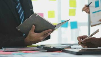 Business team collaboration discussing working analyzing with financial data and marketing growth report graph in team, presentation and brainstorming to strategy planning making profit of company. video