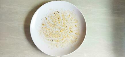 Top view of empty plate, dirty after the meal is finished isolate with clipping path, sauce smeared on a plate. photo