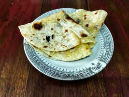 Chapati, also known as roti, rotli, safati, shabaati, phulka, chapo, and roshi photo