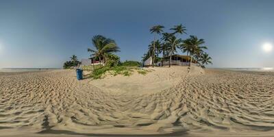 360 hdri panorama with coconut trees on ocean coast near tropical shack or open air cafe on beach in equirectangular spherical seamless projection photo