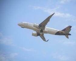 New Delhi, India, July 16 2023 - Vistara Airbus A320 neo take off from Indra Gandhi International Airport Delhi, Vistara domestic aeroplane flying in the blue sky during day time photo