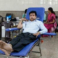 Delhi, India, July 19 2023 - Blood donor at Blood donation camp held at Balaji Temple, Vivek Vihar, Delhi, India, Image for World blood donor day on June 14 every year, Blood Donation Camp at Temple photo